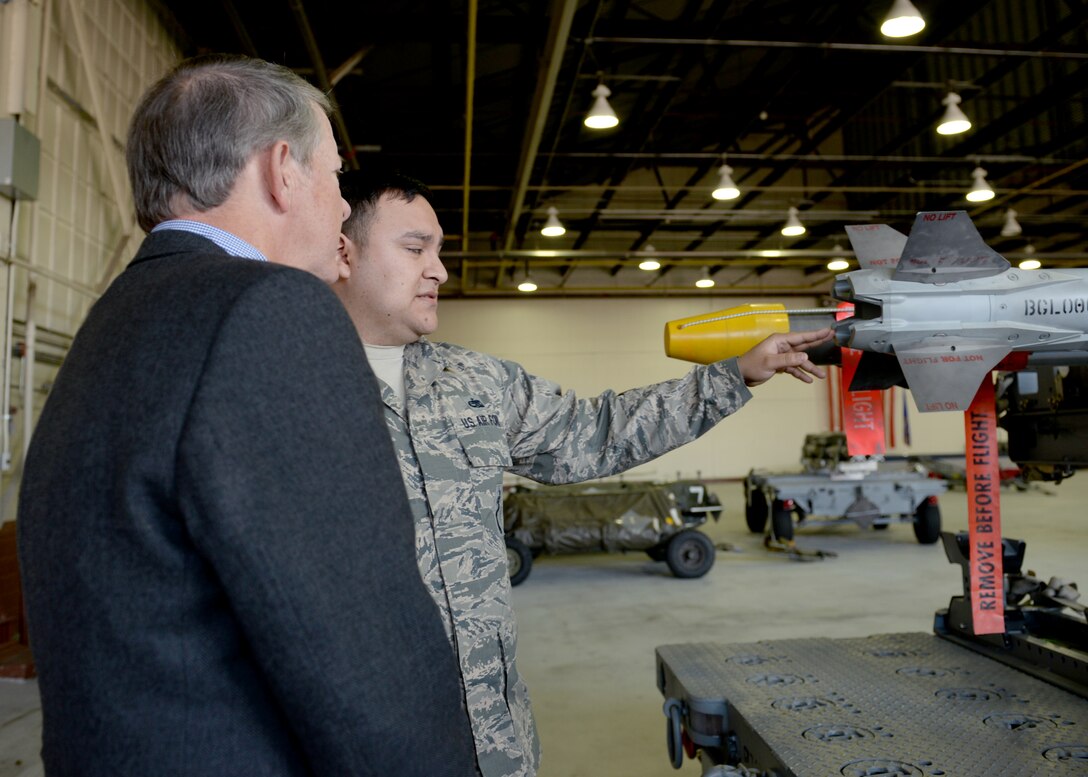 U.S. Air Force Tech. Sgt. Patterson, a weapons load crew chief assigned to the 1st Maintenance Group, briefs retired Chief Master Sgt. of the Air Force Rodney J. McKinley on the weapons at Langley Air Force Base, Va., March 18, 2016. McKinley served as a crew chief for the 3rd Tactical Fighter Wing at Clark Air Force Base, Philippines, from June 1987 to 1991 before serving as the top enlisted Airman. (U.S. Air Force photo by Airman 1st Class Kaylee Dubois)