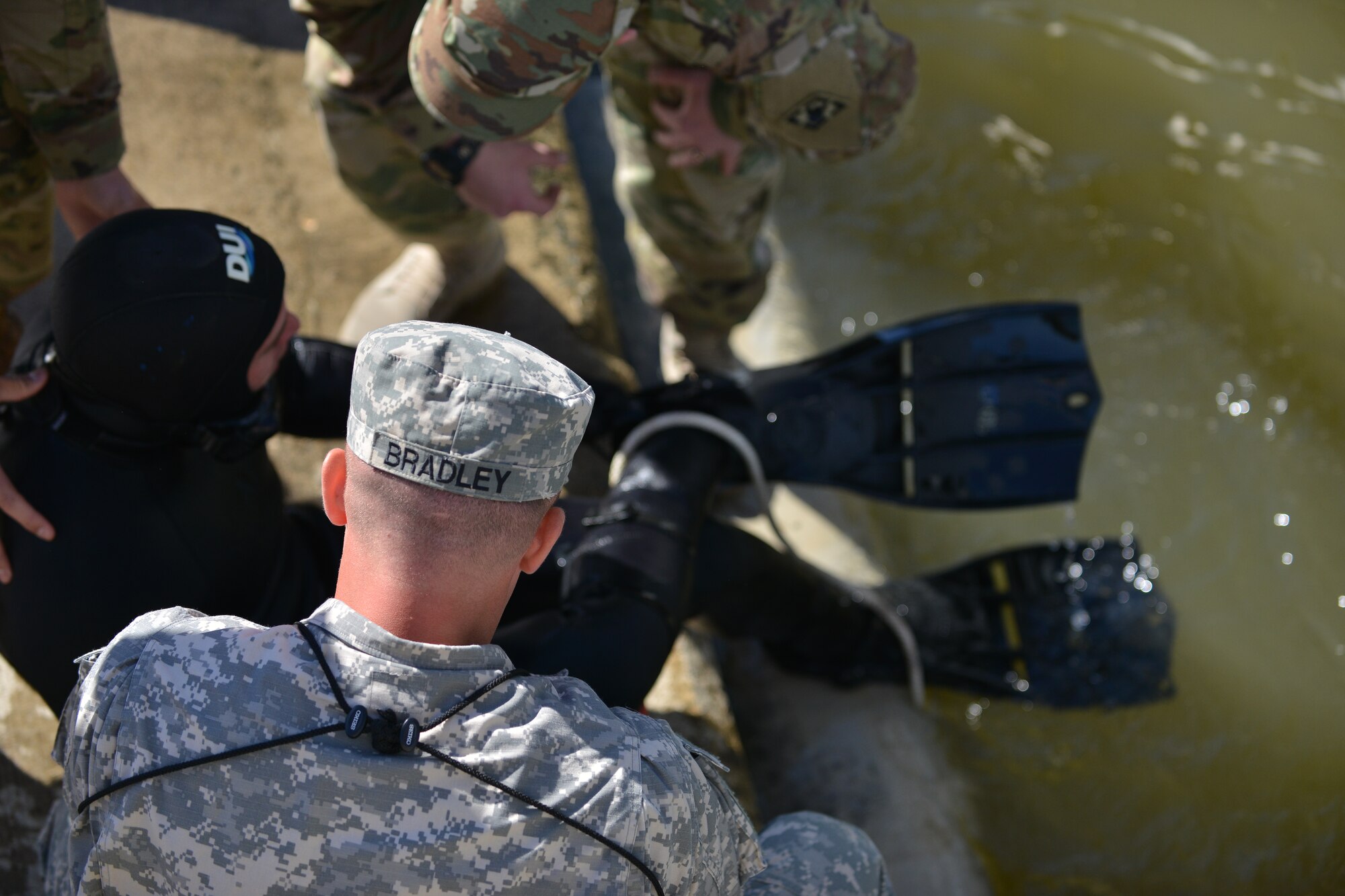 U.S. Soldiers check Sgt. Gordon Yeaple, a salvage diver and noncommissioned officer in charge with the 569th Engineer Dive Detachment, during a Salvage Dive Rodeo training at Fort Eustis, Va., March 18, 2016. Yeaple’s simulated taking on bad air during a dive and was rendered unconscious for the purposes of the upgrade task training exercise. (U.S. Air Force photo by Staff Sgt. Natasha Stannard)