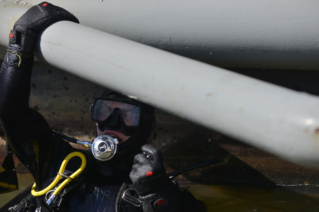 U.S. Army Sgt. Gordon Yeaple, a salvage diver and noncommissioned officer in charge with the 569th Engineer Dive Detachment, prepares to dive during a Salvage Dive Rodeo training at Fort Eustis, Va., March 18, 2016. Before and during the dive, the Soldiers practice safety checks on the equipment and divers to ensure tasks are completed without risking the lives. (U.S. Air Force photo by Staff Sgt. Natasha Stannard)