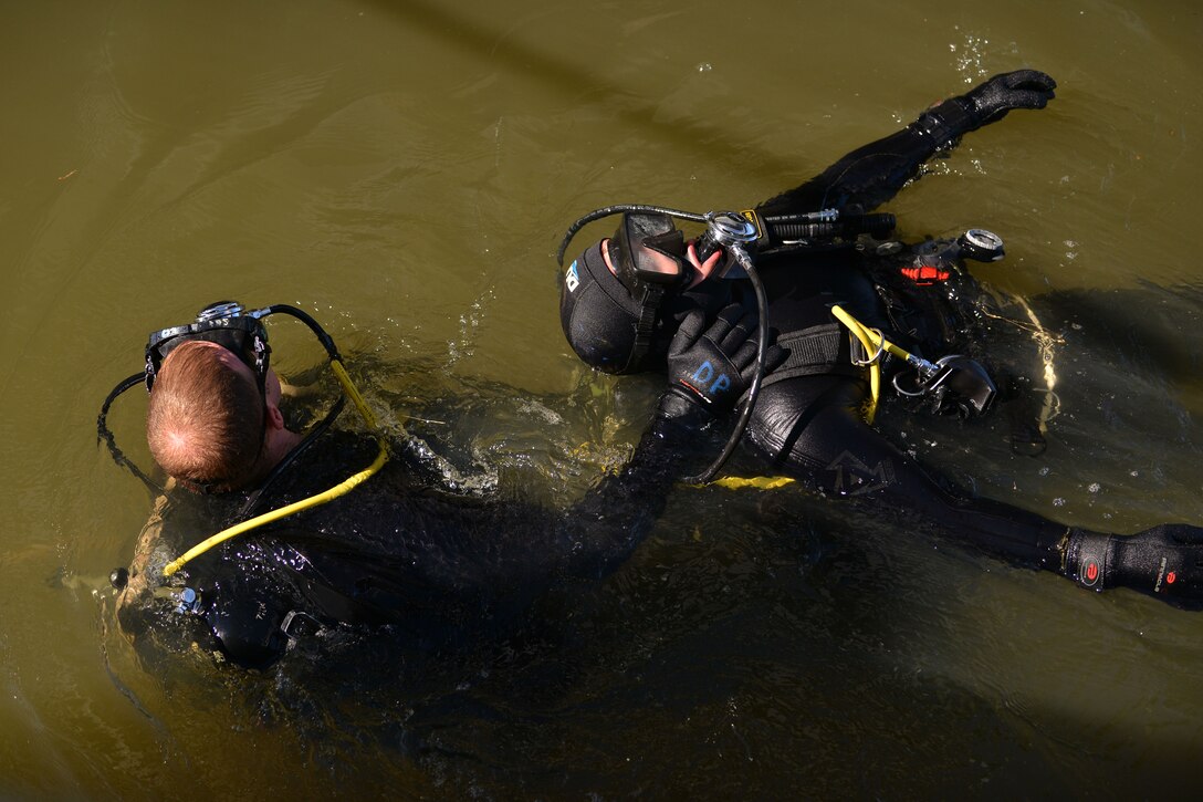 U.S. Army Spc. David Plummer, a second class diver with the 569th Engineer Dive Detachment, rescues Sgt. Gordon Yeaple, a salvage diver and noncommissioned officer in charge with the 569th Engineer Dive Detachment, during a Salvage Dive Rodeo training at Fort Eustis, Va., March 18, 2016. The rodeo is a yearly upgrade training event that allows divers to accomplish tasks that they were not introduced to in the field. (U.S. Air Force photo by Staff Sgt. Natasha Stannard)