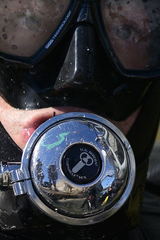 U.S. Army safety divers with the 569th Engineer Dive Detachment stand-by as Sgt. Gordon Yeaple, a salvage diver and noncommissioned officer in charge with the 569th Engineer Dive Det., dives into the James River at Fort Eustis, Va., March 18, 2016. As part of a yearly training, Yeaple simulated being unconscious due to breathing in too much carbon monoxide, so that the safety swimmer could complete a rescue task to upgrade his proficiency as a diver. (U.S. Air Force photo by Staff Sgt. Natasha Stannard)