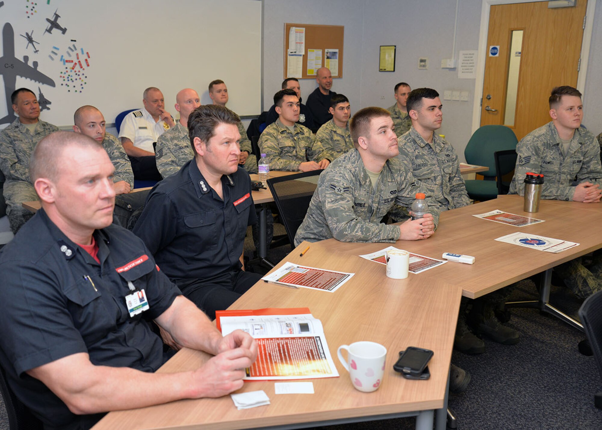 Defence Fire Service and Local National Direct Hire civilian and U.S. Air Force active-duty firefighters listen to their instructor during the “Courage to be Safe” course March 9, 2016, on RAF Mildenhall, England. The course focused on 16 firefighter life-safety initiatives and also covered topics including the importance of drivers/operators of emergency vehicles, seatbelts and safe driving. (U.S. Air Force photo by Karen Abeyasekere/Released)