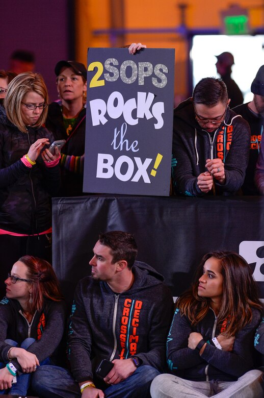 Spectators hold up a sign supporting 2nd Space Operations Squadron competitors during the CrossFit Games 16.4 Open Announcement at Schriever Air Force Base, Colorado, Thursday, March 17, 2016.  Schriever hosted the event which, between live stream and recorded viewings, is expected to reach an estimated 5.5 million viewers.  (U.S. Air Force photo/Christopher DeWitt)