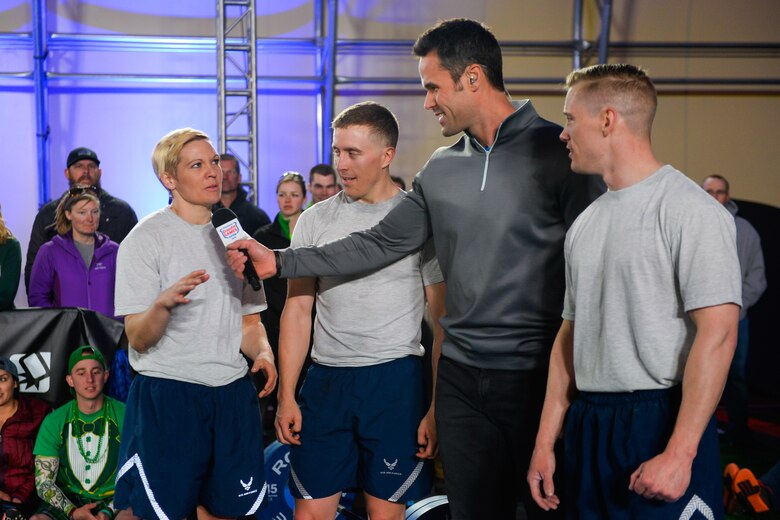 Second Lt. Jessica Trundy, 4th Space Operations Squadron, answers a question from Rory McKernan, CrossFit Games host, following the CrossFit Games 16.4 Open Announcement at Schriever Air Force Base, Colorado, Thursday, Mar. 17, 2016.  Trundy, along with fellow Airmen 1st Lt. Greg Overton (center) and 1st Lt. Mark Skinner (right) earned the opportunity to compete alongside top CrossFit Games athletes, Katrin Davidsdottir and Sara Sigmundsdottir, at a qualifying event March 11.  (U.S. Air Force photo/Christopher DeWitt)