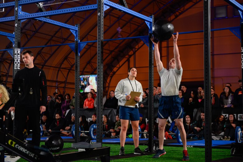 Staff Sgt. Ana Shockey, 50th Force Support Squadron, judges 1st Lt. Mark Skinner, 2nd Space Operations Squadron, during the CrossFit Games 16.4 Open Announcement at Schriever Air Force Base, Colorado, Thursday, March 17, 2016.  Both Shockey and Skinner earned the right to participate in the event based on their qualifying event performances held a week earlier.  (U.S. Air Force photo/Christopher DeWitt)