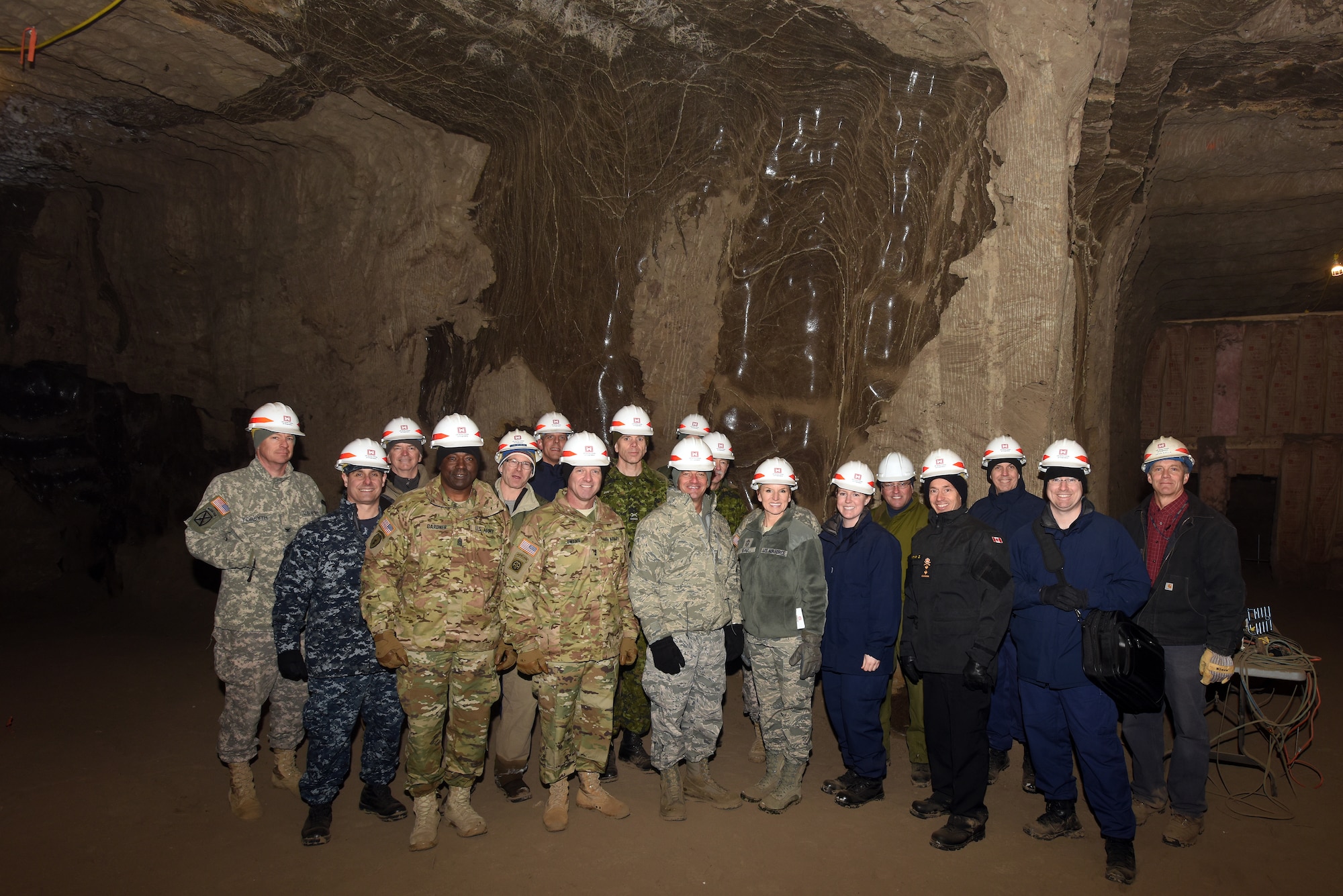 General Officer/Flag Officer summit attendees pose for a group photo upon conclusion of a Permafrost Tunnel tour in Fox, Alaska, March 16. During the tour, attendees were informed on the consequences of Permafrost thawing and the impact it will have on infrastructure. The purpose of the annual GO/FO is to strengthen partnerships of senior military officers and enlisted leaders, joint and bi-national, as well as discuss current and future Arctic and Alaskan challenges and joint capabilities. (U.S. Air Force photo/Tech. Sgt. John Gordinier)