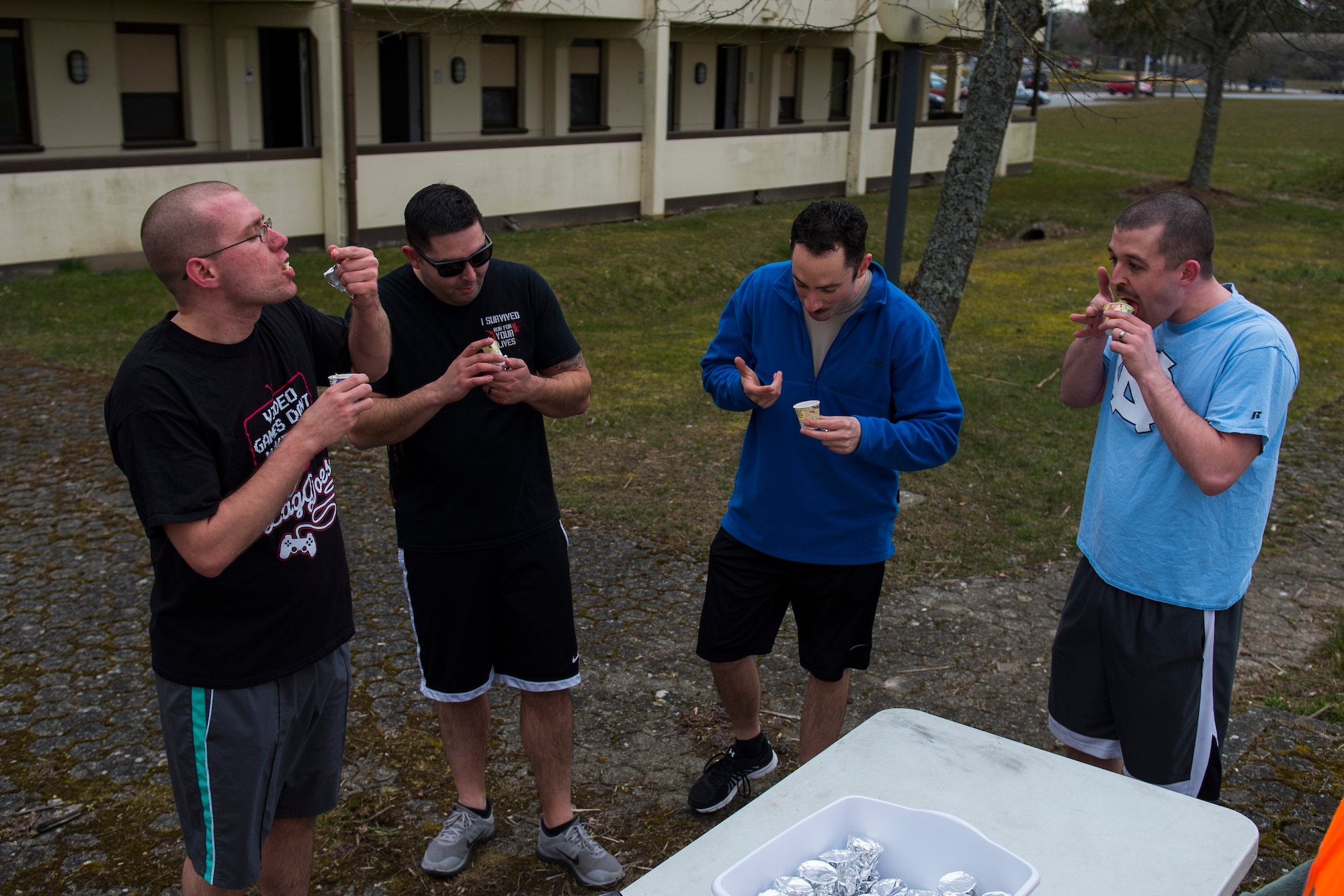 A team attempts to complete a challenge by eating a mystery food item during the Amazing Nutrition 5k Challenge at Spangdahlem Air Base, Germany, Mar. 22, 2016. Teams at this station were given the choice between eating a mystery food item and performing additional exercises. (U.S. Air Force photo by Senior Airman Luke Kitterman/Released)