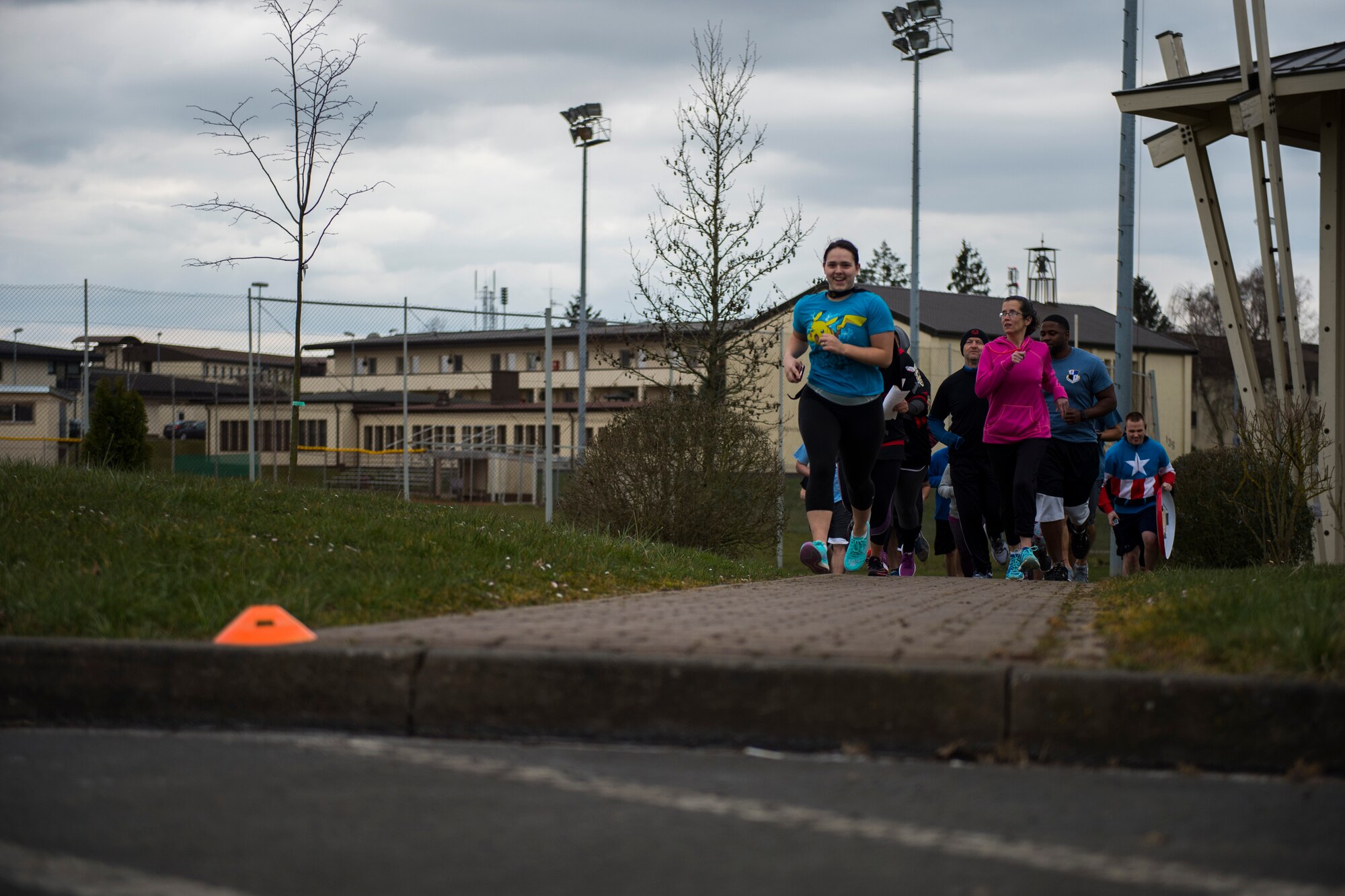 Participants follow cones on the ground during the Amazing Nutrition 5k Challenge at Spangdahlem Air Base, Germany, Mar. 22, 2016. The cones were set up to help participants follow the correct course that covered a wide area of the base. (U.S. Air Force photo by Senior Airman Luke Kitterman/Released)