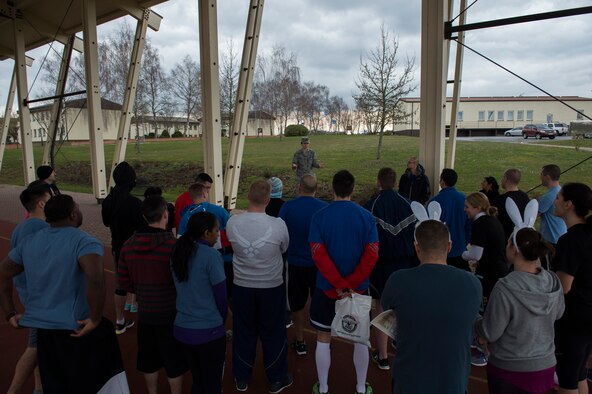 U.S. Air Force Capt. Denise Campbell, 52nd Aerospace Medicine Squadron health promotion dietitian, speaks to participants before the start of the Amazing Nutrition 5k Challenege at Spangdahlem Air Base, Germany, Mar. 22, 2016. More than 30 participants combined to make eight teams competing against one another. (U.S. Air Force photo by Senior Airman Luke Kitterman/Released)