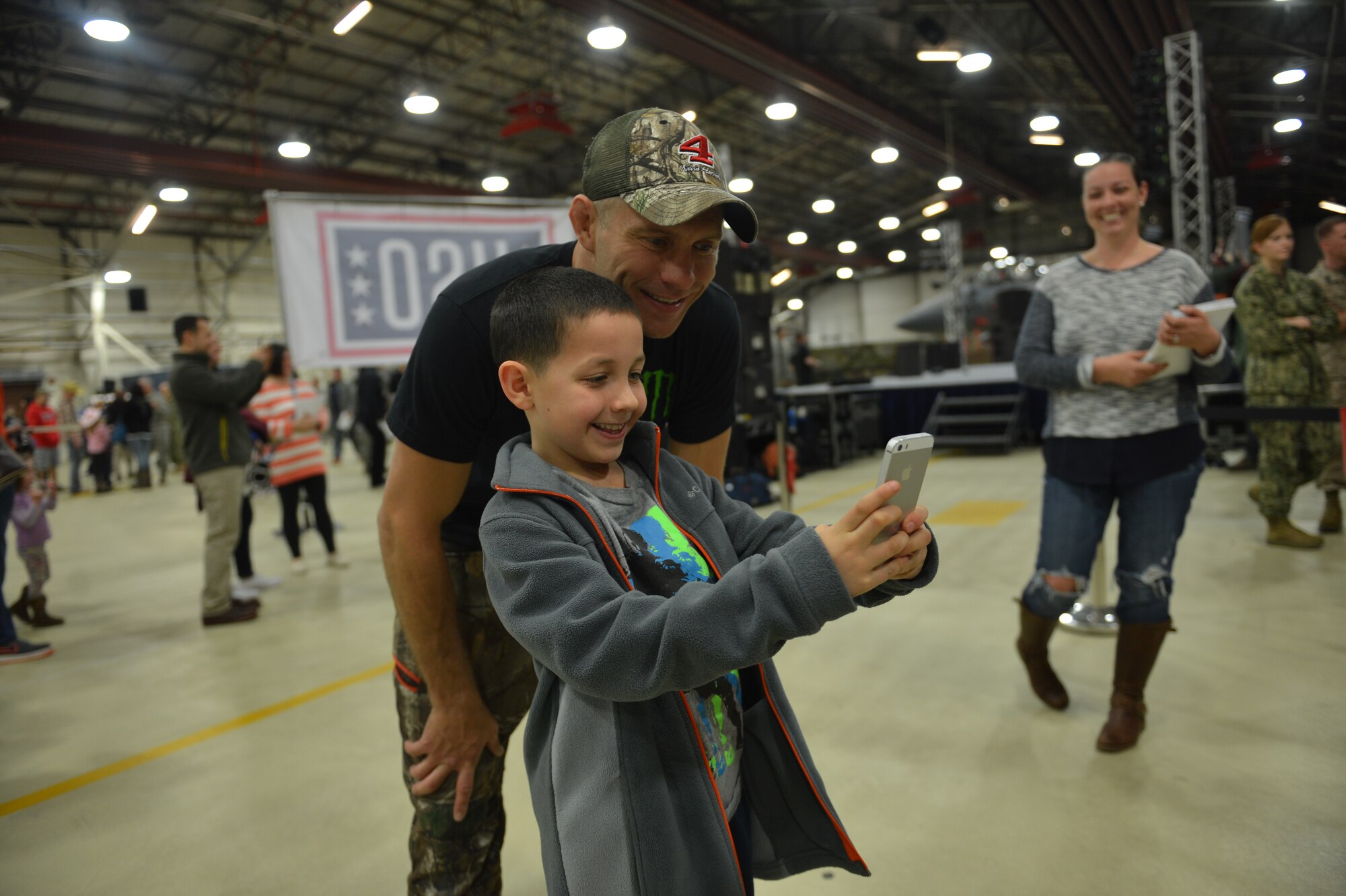 Ultimate Fighting Championship fighter Donald “Cowboy” Cerrone poses for a photo with a fan during the United Service Organizations tour at Royal Air Force Lakenheath, England, March 16, 2016. Over the course of two hours, five celebrities entertained more than 400 attendees with interactive speeches, question and answer engagements and live performances. (U.S. Air Force photo/Senior Airman Nigel Sandridge)