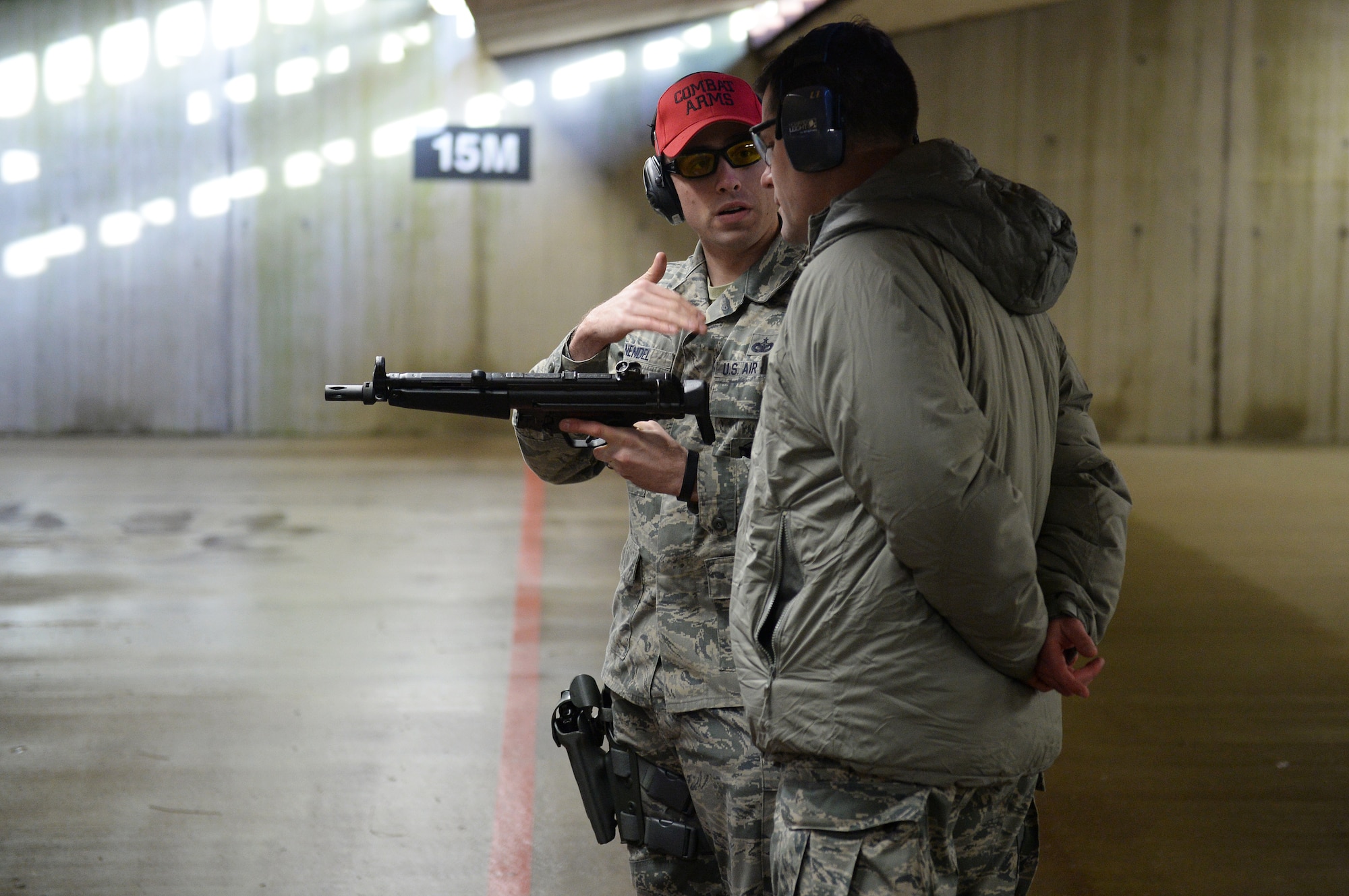 Staff Sgt. Bradley Nendel, 48th Security Forces Squadron combat arms instructor,  instructs  Col. John Devillier, 88th Air Base Wing commander, on firing an MP5 submachine gun during an Installation Excellence Selection Board visit on Royal Air Force Feltwell, England, Jan. 15, 2015. The IESB visited RAF Lakenheath to determine the winner of the Commander in Chief’s Annual Award for Installation Excellence. (U.S. Air Force photo by Staff Sgt. Emerson Nuñez/Released)