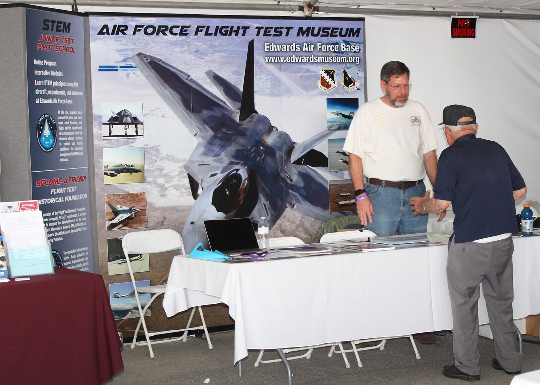 Danny Bazzell, former Edwards AFB Civilian Military Support Group president and volunteer, mans the Air Force Flight Test Museum booth at the L.A. County Air Show in Lancaster March 20. (U.S. Air Force photo by Melissa Buchanan)