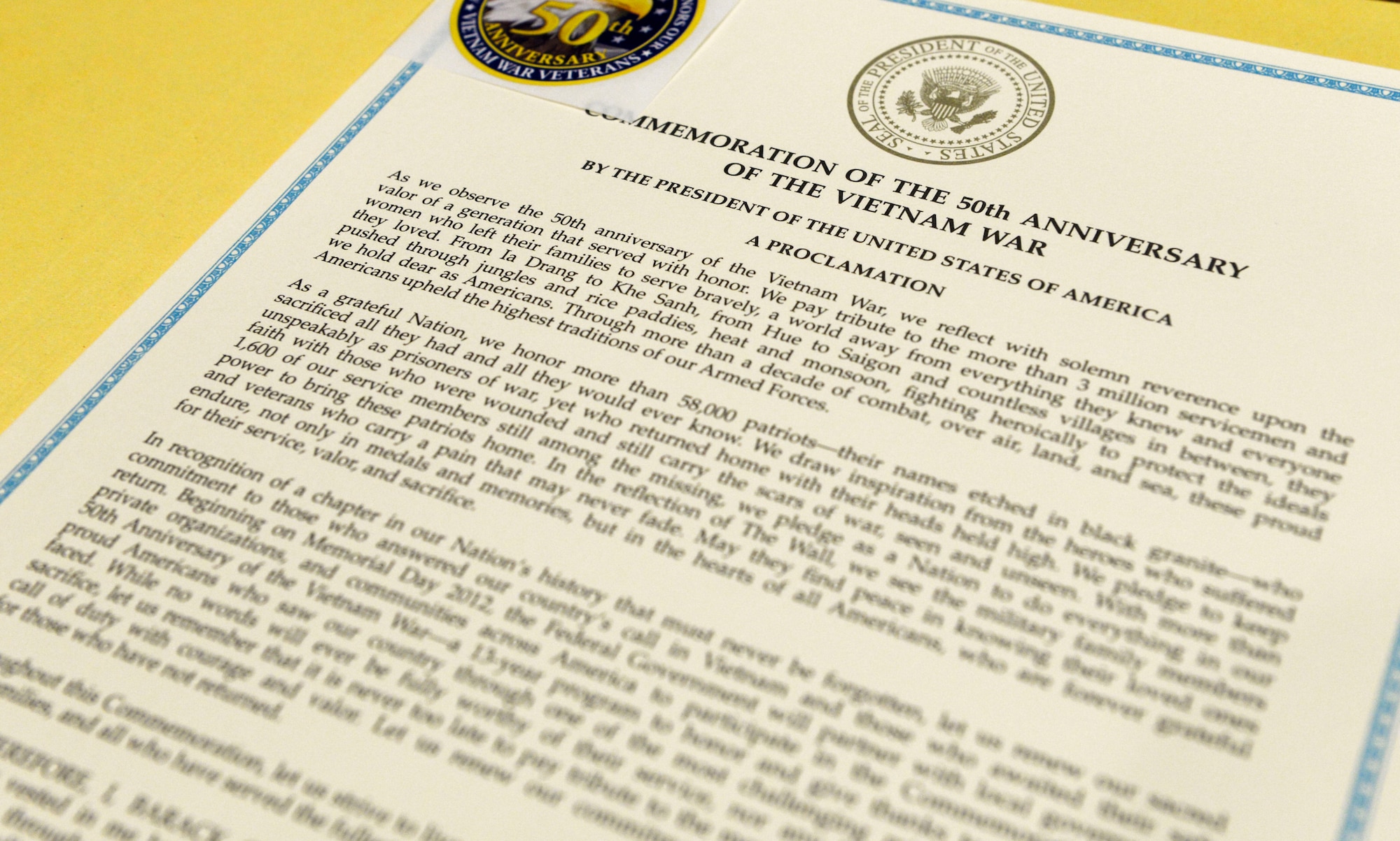 A copy of the Proclamation by the President of the United States commemorating the 50th Anniversary of the Vietnam War, lays on a table during a 50th Anniversary Commemoration Ceremony held inside the Air Force Materiel Command headquarters building, March 16, 2016. In addition to the certificates individuals received a commemorative pin.  (U.S. Air Force photo by Wesley Farnsworth / Released)  