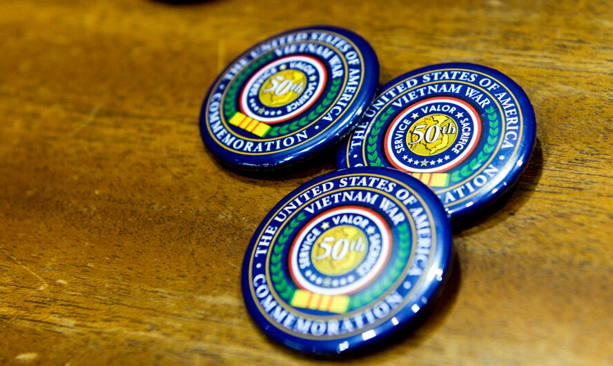 Vietnam War 50th Anniversary commemorative pins lay on a table during a 50th Anniversary Commemoration Ceremony held inside the Air Force Materiel Command headquarters building, March 16, 2016. In addition to the certificates individuals received a copy of the Proclamation by the President of the United States commemorating the 50th Anniversary of the Vietnam War. (U.S. Air Force photo by Wesley Farnsworth / Released)    