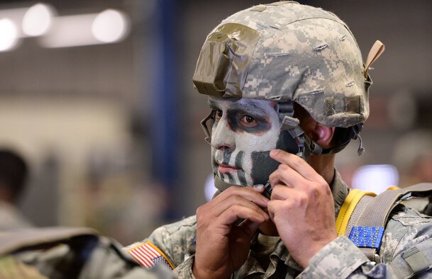 U.S. Army Reserve Capt. Phil Spence, 412th Civil Affairs Battalion civil-military operations center chief, fastens his helmet strap prior to a static line jump over Wright-Patterson Air Force Base, Ohio, March 19, 2016. The 412th is an Army Reserve unit out of Whitehall, Ohio, and is required to complete eight jumps per year to remain current. (U.S. Air Force photo/Wesley Farnsworth)