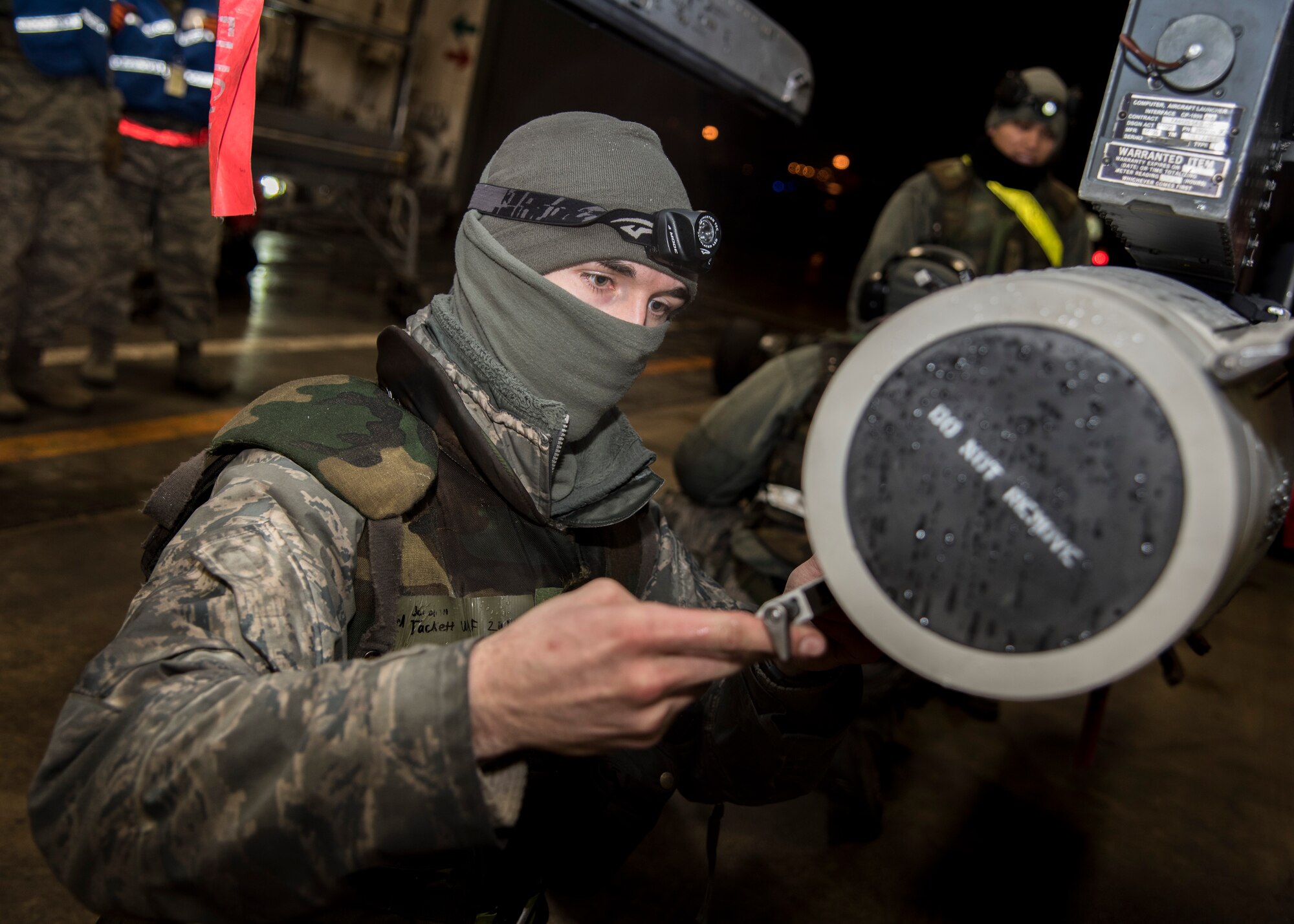 U.S. Air Force Senior Airman Jordan Tackett, a weapons load crew member with the 35th Aircraft Maintenance Squadron, secures a tail fin onto an armament during exercise Beverly Sunrise 16-03 at Misawa Air Base, Japan, March 22, 2016. Tackett and his team worked late into the night to fully arm an F-16 Fighting Falcon waiting to take off. (U.S. Air Force photo by Senior Airman Patrick S. Ciccarone)