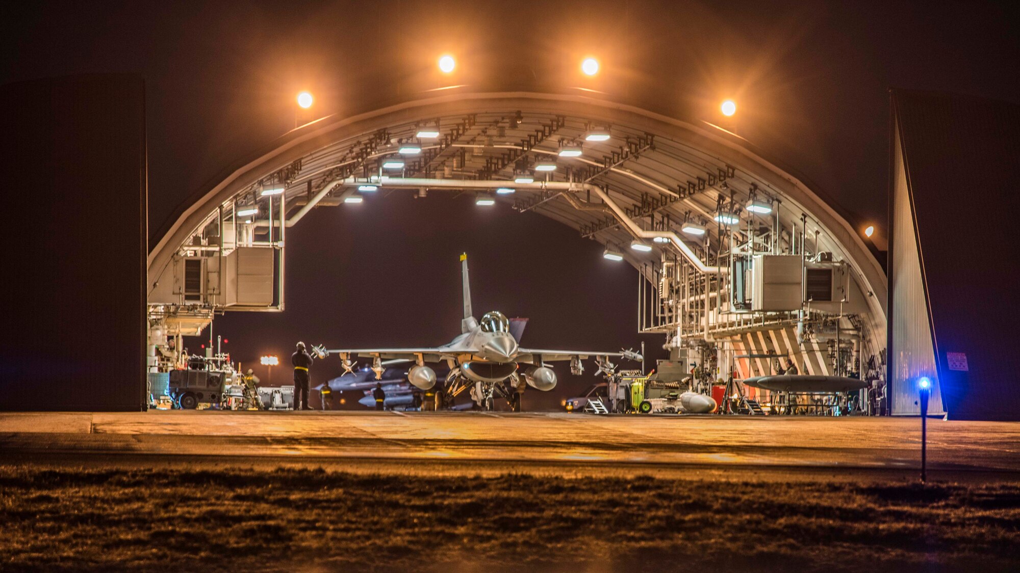 An F-16 Fighting Falcon arrives at a hardened shelter after returning from a flight during exercise Beverly Sunrise 16-03 at Misawa Air Base, Japan, March 22, 2016. The F-16 is a multi-role fighter aircraft capable of offensively and defensively posturing itself for both air-to-air and air-to-ground missions. (U.S. Air Force photo by Senior Airman Patrick S. Ciccarone)