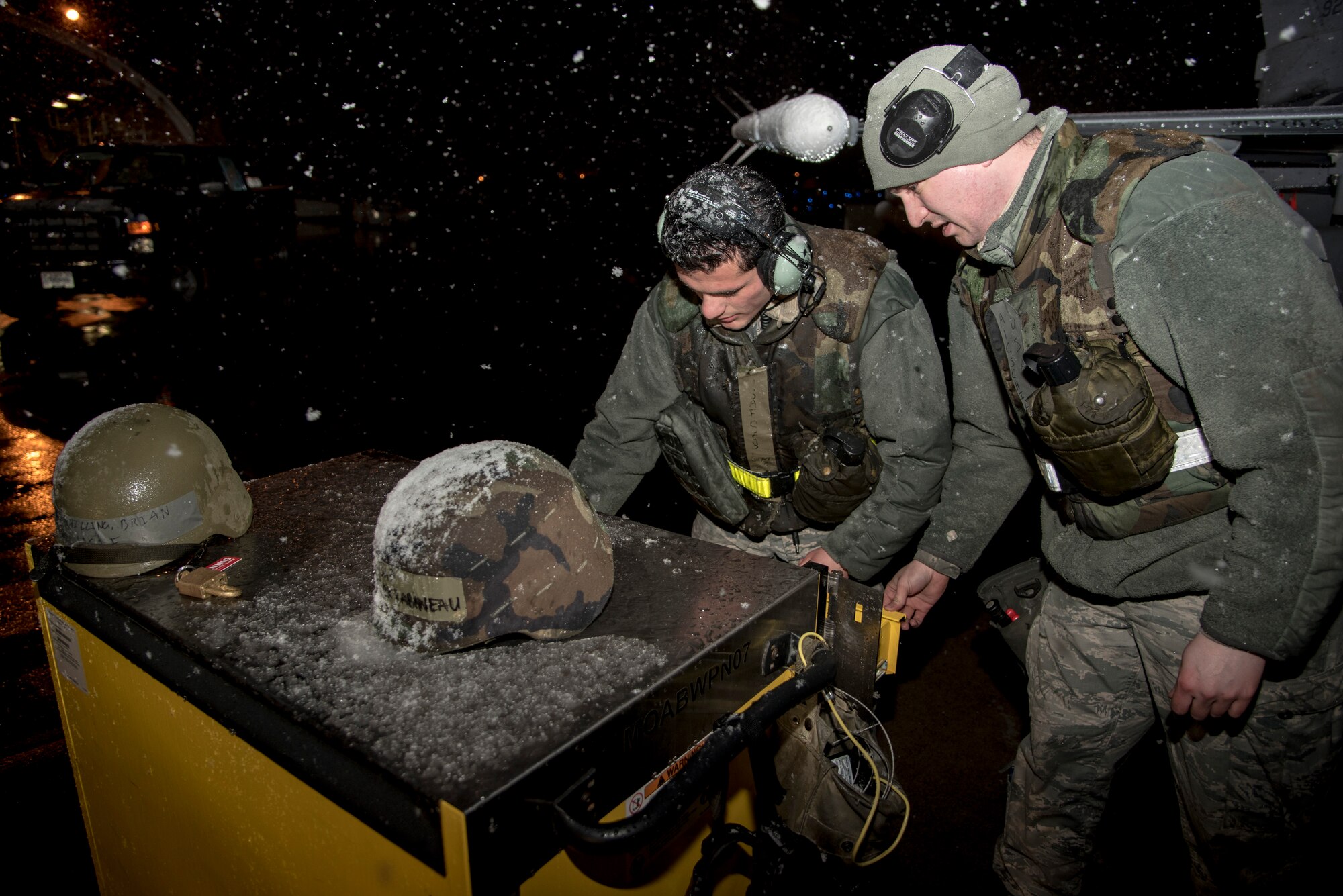 U.S. Air Force Senior Airman Mateo Palacios, a weapons load crew member with the 35th Aircraft Maintenance Squadron, and Staff Sgt. Mark Babineau, a weapons load crew chief with the 35th AMXS, search for a tool during exercise Beverly Sunrise 16-03 at Misawa Air Base, Japan, March 22, 2016. Load crew teams are composed of three Airmen, each with different responsibilities, but with the primary objective of loading weapons systems as quickly and efficiently as possible. (U.S Air Force photo by Senior Airman Patrick S. Ciccarone) 