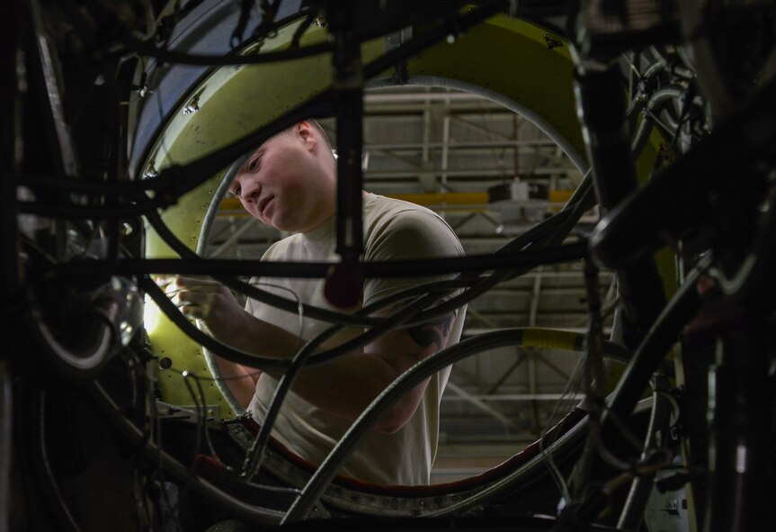 Airman 1st Class Brandon King, 374th Maintenance Squadron aerospace propulsion journeyman, works on a dummy plug on a quick engine change kit at Yokota Air Base, Japan, March 3, 2016. The quick engine change section inspects, replaces and cleans all of the engine parts such as the wiring, harnesses and structural frame. (U.S. Air Force photo by Senior Airman David Owsianka/Released)