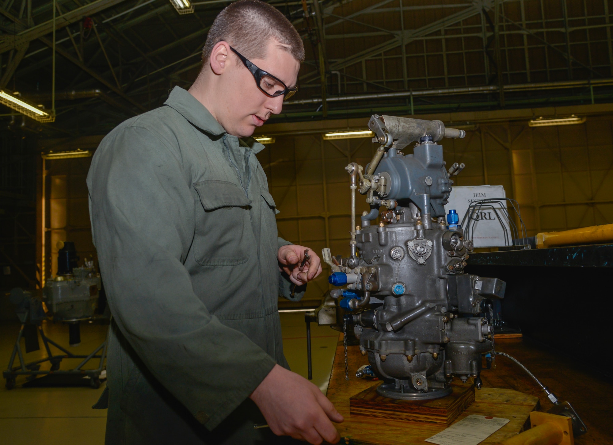 Staff Sgt. David Pinckney, 374th Maintenance Squadron aerospace propulsion craftsman, inspects a C-130 Hercules fuel control system at Yokota Air Base, Japan, March 3, 2016. The props flight is split into four sections: the propeller section, quick engine change section, jet engine intermediate maintenance section and the test cell section. (U.S. Air Force photo by Senior Airman David Owsianka/Released)