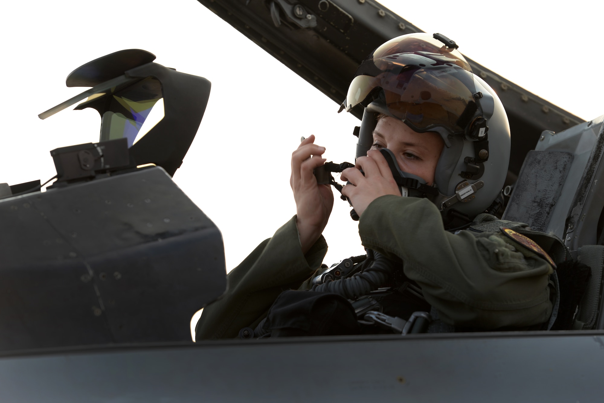 U.S. Air Force 1st Lt. Brittany Trimble, 36th Fighter Squadron pilot, secures her helmet before takeoff, Feb. 15, 2016, at Korat Royal Thai Air Force Base, Thailand. Trimble has been flying F-16 Fighting Falcons actively since October 2015. (U.S. Air Force photo by Staff Sgt. Amber E. Jacobs)