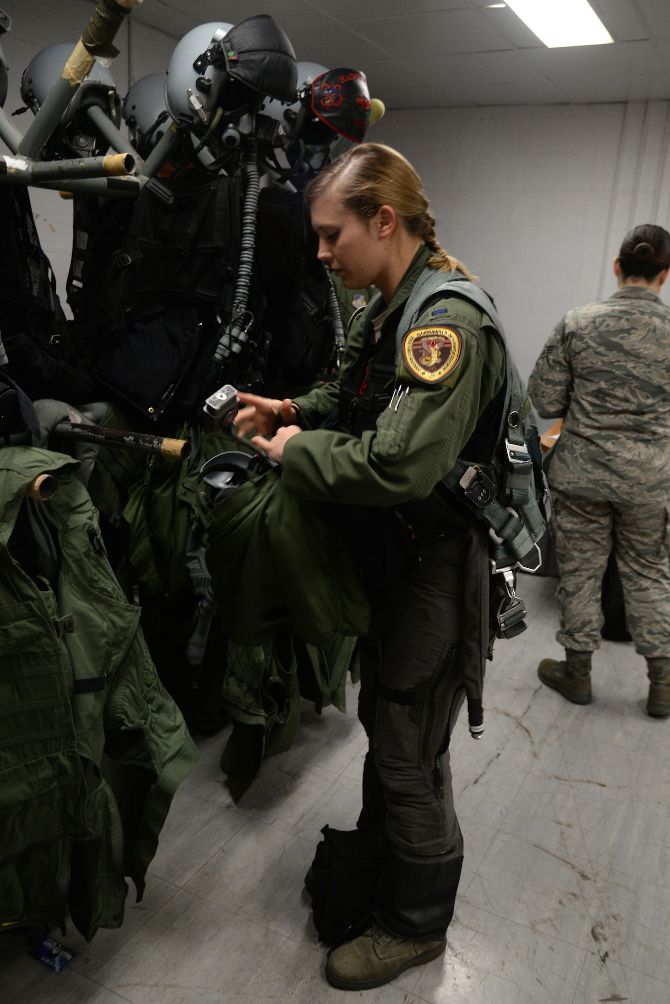 U.S. Air Force 1st Lt. Brittany Trimble, 36th Fighter Squadron pilot, puts on her air flight crew equipment, Feb. 15, 2016, at Korat Royal Thai Air Force Base, Thailand. For Trimble her goal of becoming a pilot was finally realized during her first experience donning her air flight crew equipment. (U.S. Air Force photo by Staff Sgt. Amber E. Jacobs)
