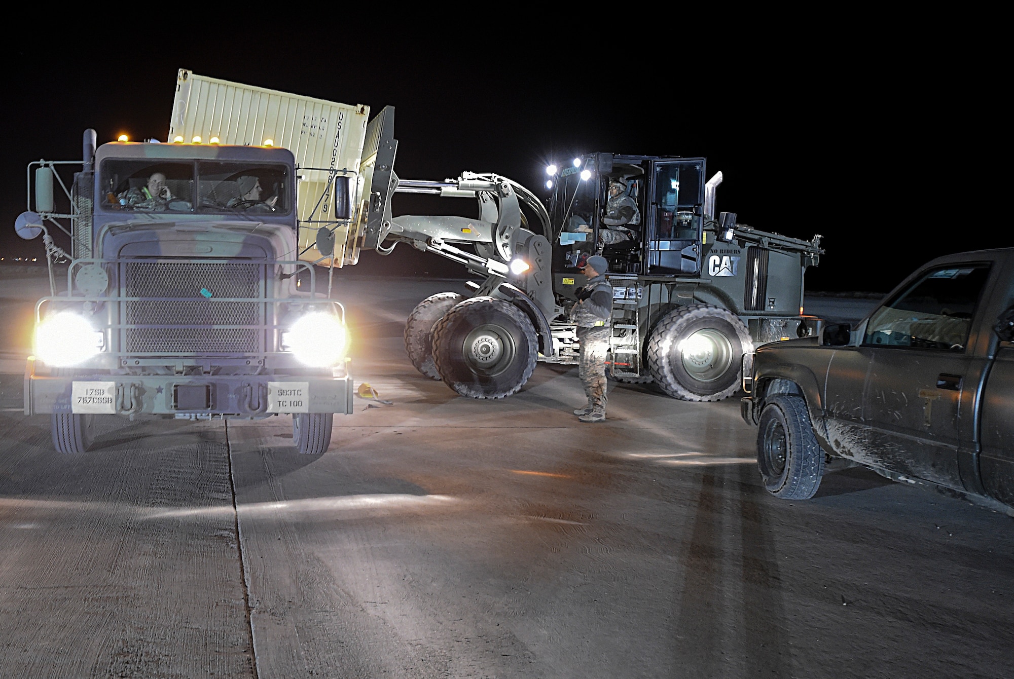 Airmen with the 821st Contingency Response Squadron Aerial Port Flight, load cargo to the back of a truck during Exercise Turbo Distribution 16-02, March 17, 2016, at Amedee Army Airfield, Calif.  The Joint Task Force Port-Opening team was deployed to demonstrate their ability to arrive at an austere airfield, receive airlifted cargo, move the cargo by truck to a forward location and stage it for distribution. (U.S. Air Force photo by Staff Sgt. Robert Hicks/Released)