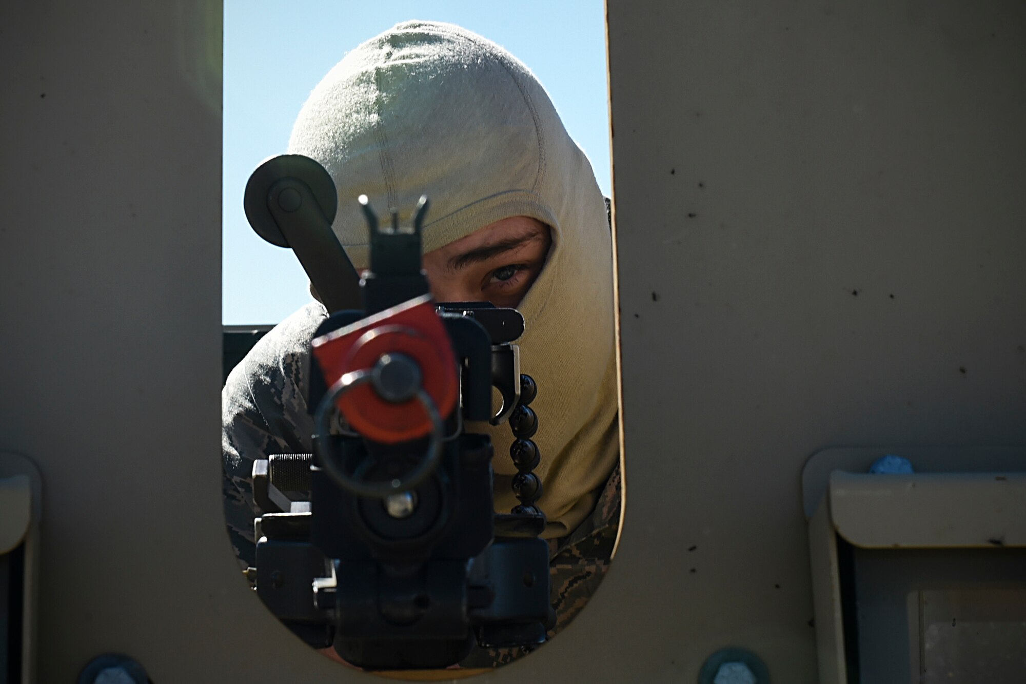 Senior Airman Dylan Saimes, 821st Contingency Response Squadron defender, looks down his iron sights while guarding an entry control point during Exercise Turbo Distribution 16-02, March 16, 2016, at Amedee Army Airfield, Calif. Turbo Distribution is used to evaluate mobility operations and expeditionary combat support. Unlike traditional, simulation based exercises, TD provides a dynamic venue with scenarios designed to challenge participants executing complex operations in a deployed environment. (U.S. Air Force photo by Staff Sgt. Robert Hicks/Released)