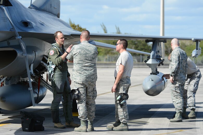 Crew chiefs listen to a pilot as he describes the jets current status following landing at Homestead Air Reserve Base, Fla., on Feb. 21, 2016. The Airmen deployed in support of an air-to-ground combat competition between the current Total Force Integration Active Associate units. (U.S. Air National Guard photo by Staff Sgt. Andrea F. Rhode)