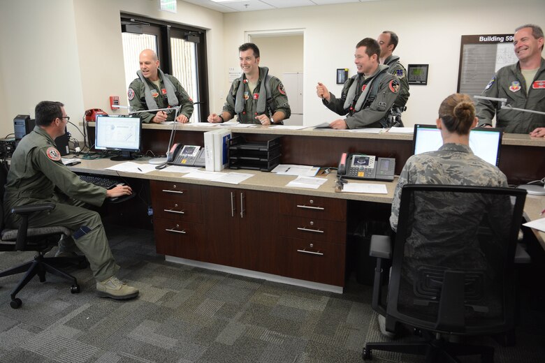 Pilots from the 176th Fighter Squadron and the 378th Fighter Squadron gather prior to their flights at Homestead Air Reserve Base, Fla., Feb. 22, 2016. The pilots, stationed at Truax Field in Madison, Wis., deployed to Homestead ARB to participate in the first air-to-ground combat competition between Total Force Integration Active Associate units. (U.S. Air National Guard photo by Staff Sgt. Andrea F. Rhode)