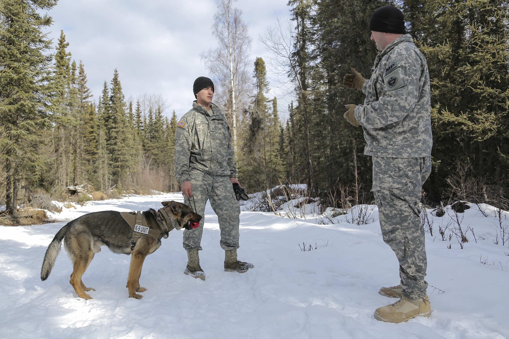 Army Staff Sgt. Daniel Turner, right, debriefs Army Pfc. Ian Smith after successfully detecting hidden simulated explosive devices during K-9 training at Joint Base Elmendorf-Richardson, Alaska, March 17, 2016. Turner is his detachment’s kennel master and Smith is a dog handler assigned to the 549th Military Working Dog Detachment. Air Force photo by Alejandro Pena