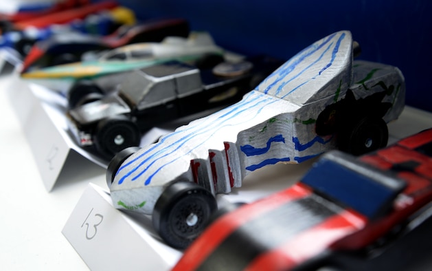 RAF Mildenhall Cub Scout Pack 215 members enter their handmade race cars in the Pinewood Derby March 19, 2016, on RAF Mildenhall, England. Each participant voted for the best car design before the races. After the voting, the cars battled for the fastest race time. (U.S. Air Force photo by Senior Airman Justine Rho/Released)