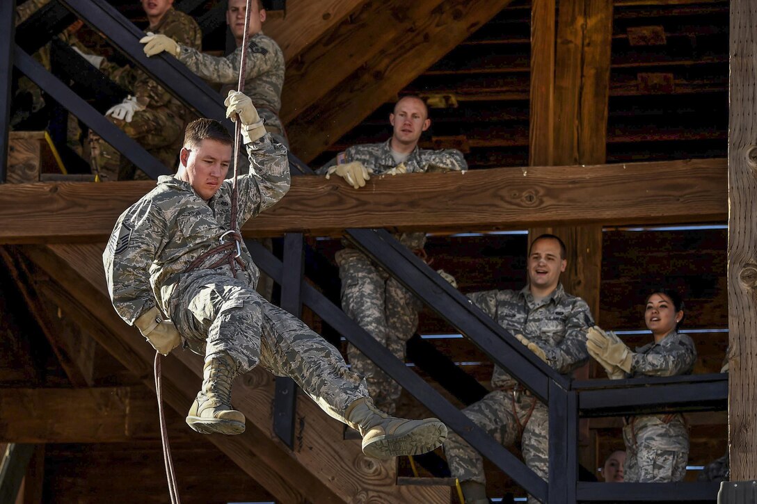 An airman rappels down the tower during Operational Contract Support Joint Exercise 2016 at Fort Bliss, Texas, March 22, 2016. Air Force photo by Staff Sgt. Jonathan Snyder