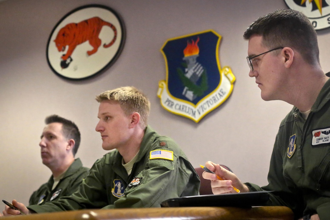 Air Force Lt. Col. Marty Ryan, left, Maj. Tim Vander Pyl, center, and Airman 1st Class Connor Smith, right, sit in on a pre-flight briefing on Joint Base McGuire-Dix-Lakehurst, N.J., March 18, 2016. Ryan and Vander Pyl are pilots and Smith is a crew chief assigned to the New Jersey Air National Guard's 108th Wing. New Jersey Air National Guard photo by Tech. Sgt. Matt Hecht