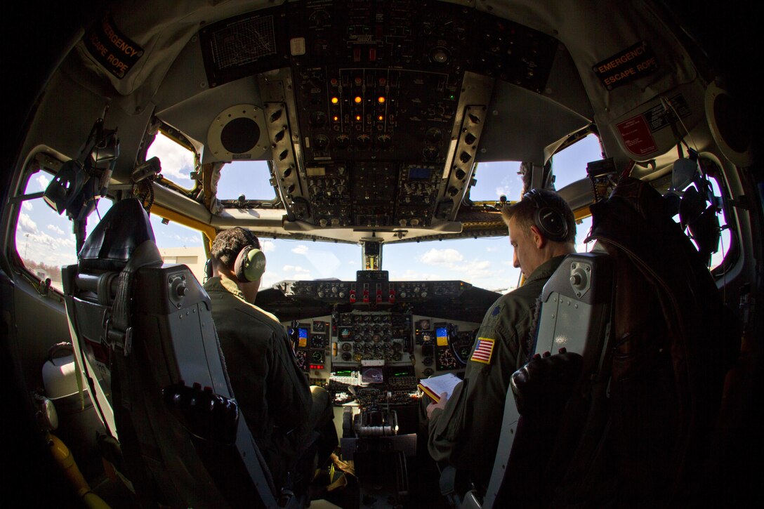 Air Force Lt. Col. Charles Tai, left, and Lt. Col. Marty Ryan go over a pre-flight checklist inside a KC-135R Stratotanker aircraft on Joint Base McGuire-Dix-Lakehurst, N.J., March 18, 2016. Tai and Ryan are pilots assigned to the New Jersey Air National Guard's 108th Wing. New Jersey Air National Guard photo by Tech. Sgt. Matt Hecht