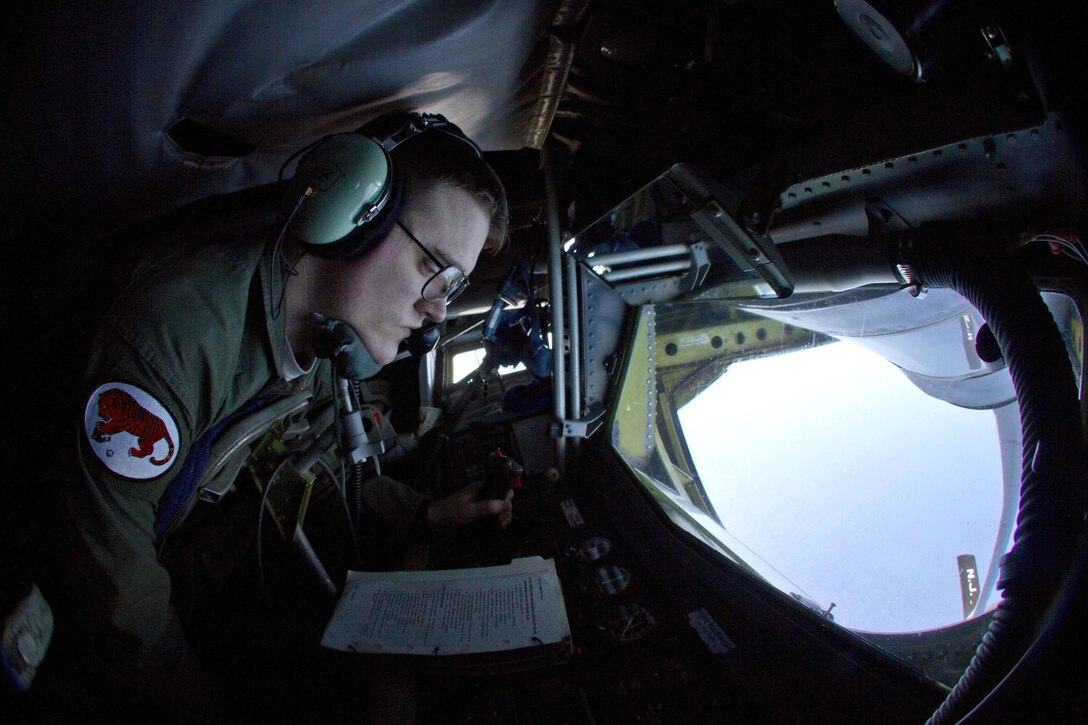 Airman 1st Class Connor Smith goes over a refueling checklist inside a KC-135R Stratotanker aircraft flying over the Atlantic Ocean, March 18, 2016. Smith is a boom operator assigned to the New Jersey Air National Guard's 108th Wing. New Jersey Air National Guard photo by Tech. Sgt. Matt Hecht