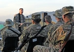 U.S. Army Chaplain (Maj.) Steve Prost, 4th Brigade Combat Team, 1st Cavalry Division, addresses soldiers and civilians during an Easter service at Forward Operating Base Gamberi in Laghman province, Afghanistan, March 31, 2013. DLA Troop Support provided a taste of home for deployed service members to enjoy during their Easter meals and palms for observing Palm Sunday. 