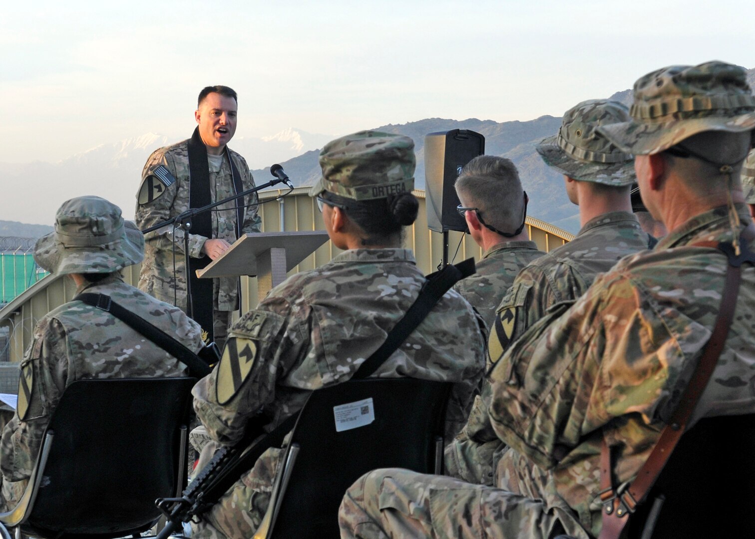 U.S. Army Chaplain (Maj.) Steve Prost, 4th Brigade Combat Team, 1st Cavalry Division, addresses soldiers and civilians during an Easter service at Forward Operating Base Gamberi in Laghman province, Afghanistan, March 31, 2013. DLA Troop Support provided a taste of home for deployed service members to enjoy during their Easter meals and palms for observing Palm Sunday. 
