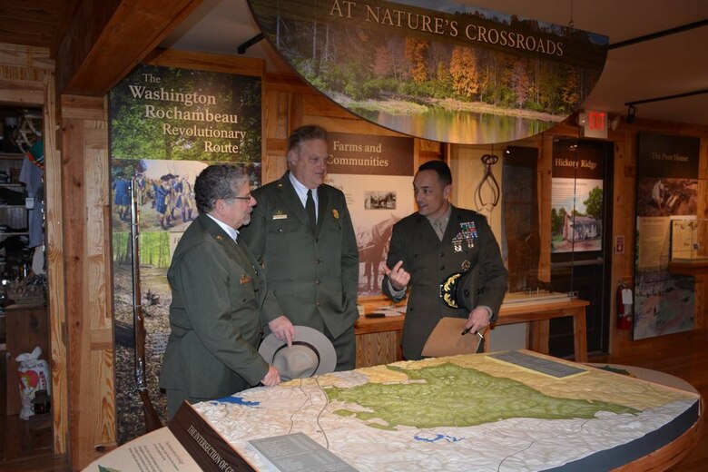Vidal Martinez, superintendent for the Prince William Forest Park, Bob Vogel, NPS National Capital Region director, and Col. Joseph Murray, MCINCR-MCB Quantico commander, discuss details of a 3-D map of the park during a rededication of the park’s Visitor Center March 19. This year marks the 80th anniversary of the park and the 100th anniversary of the National Park Service.