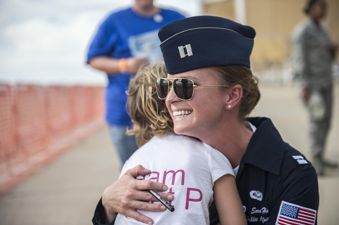 Air Force Capt. Sara Harper hugs a special guest at Davis-Monthan Air Force Base in Tucson, Ariz., March 11, 2016. Harper is a pilot assigned to the Thunderbirds, the Air Force’s air demonstration squadron. Air Force photo by Senior Airman Jason Couillard