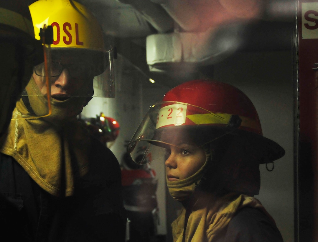 Navy Seaman Samantha Thomas, right, and Petty Officer 2nd Class Joseph Woodson receive instruction during a damage control flooding drill aboard the USS Blue Ridge in the South China Sea, March 11, 2016. Thomas and Woodson are damage controlmen. The Blue Ridge is on patrol to ensure security in the Asia-Pacific region. Navy photo by Petty Officer 1st Class Mike Story