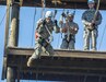 Spc. Christopher L. Ubias, practical nursing specialist, 5502nd U.S. Army Hospital, of Denver, Colorado, rides a zip line to the ground during a team building exercise, March 8, 2016 at The Army Reserve Medical Command's 2016 Best Warrior competition at Fort Gordon, Ga. (U.S. Army photo by Sgt. 1st Class Brian Hamilton 108th Training Command- Initial Entry Training Public Affairs)