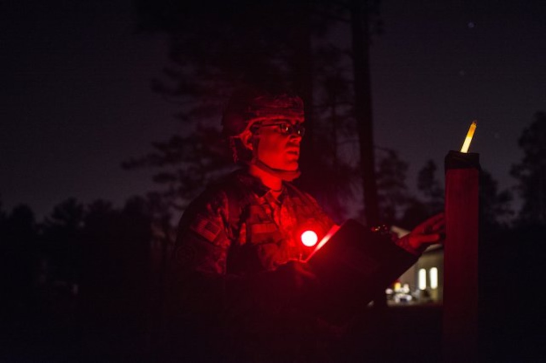 Sgt. Abraham Amavisca, a practical nursing noncommissioned officer with the 7305th Medical Training Support Battalion out of Sacramento, California checks his azimuth one last time before venturing out to his first point during the night land navigation March 8, 2016 as part of Army Reserve Medical Command's 2016 Best Warrior at Fort Gordon, Ga. (U.S. Army photo by Sgt. 1st Class Brian Hamilton 108th Training Command- Initial Entry Training Public Affairs)