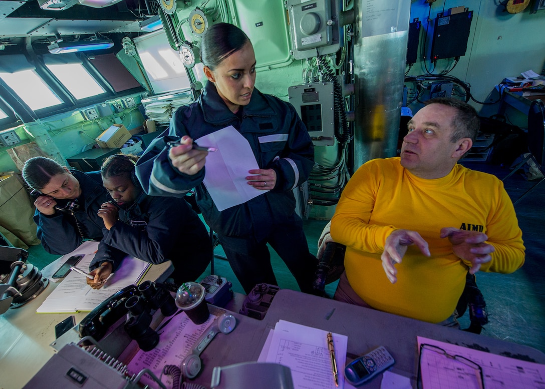 Navy Lt. Cmdr. Donald Devine, right, and Senior Chief Quartermaster Aurora Robles discuss tracking of landing craft, air cushion assets while Seamen Ashley Patterson and Danielle Barclay record an approaching vessel in debark control aboard the amphibious assault ship USS Boxer in the East Sea, March 12, 2016. Navy photo by Petty Officer 1st Class Doug Bedford