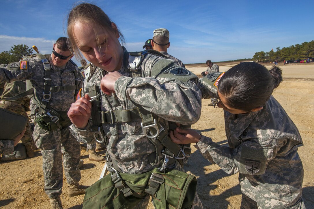 An Army jumpmaster, right, inspects Sgt. 1st Class Keli Mule’s chute before participating in a joint training airborne operation at Coyle drop zone at Joint Base McGuire-Dix-Lakehurst, N.J., March 12, 2016. Mule is a paratrooper assigned to the 404th Civil Affairs Battalon (Airborne), Army Reserve. New Jersey National Guard photo by Air Force Tech. Sgt. Matt Hecht