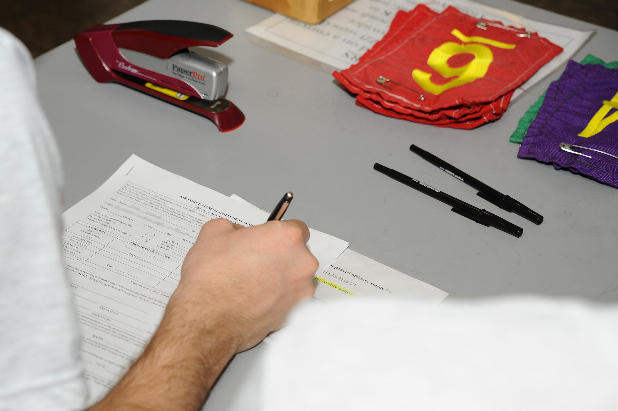 U.S. Air Force Airman 1st Class Brendon Davis, 355th Logistics Readiness Squadron material management apprentice, reviews a 36-2905 Fitness Screening Questionnaire before a fitness assessment at Davis-Monthan Air Force Base, Ariz., Feb. 24, 2016. The D-M fitness assessment cell, which administers the fitness assessments, is in the process of transitioning all physical paperwork to digital copies to save time and resources.  (U.S. Air Force photo by Airman 1st Class Mya M. Crosby/Released)