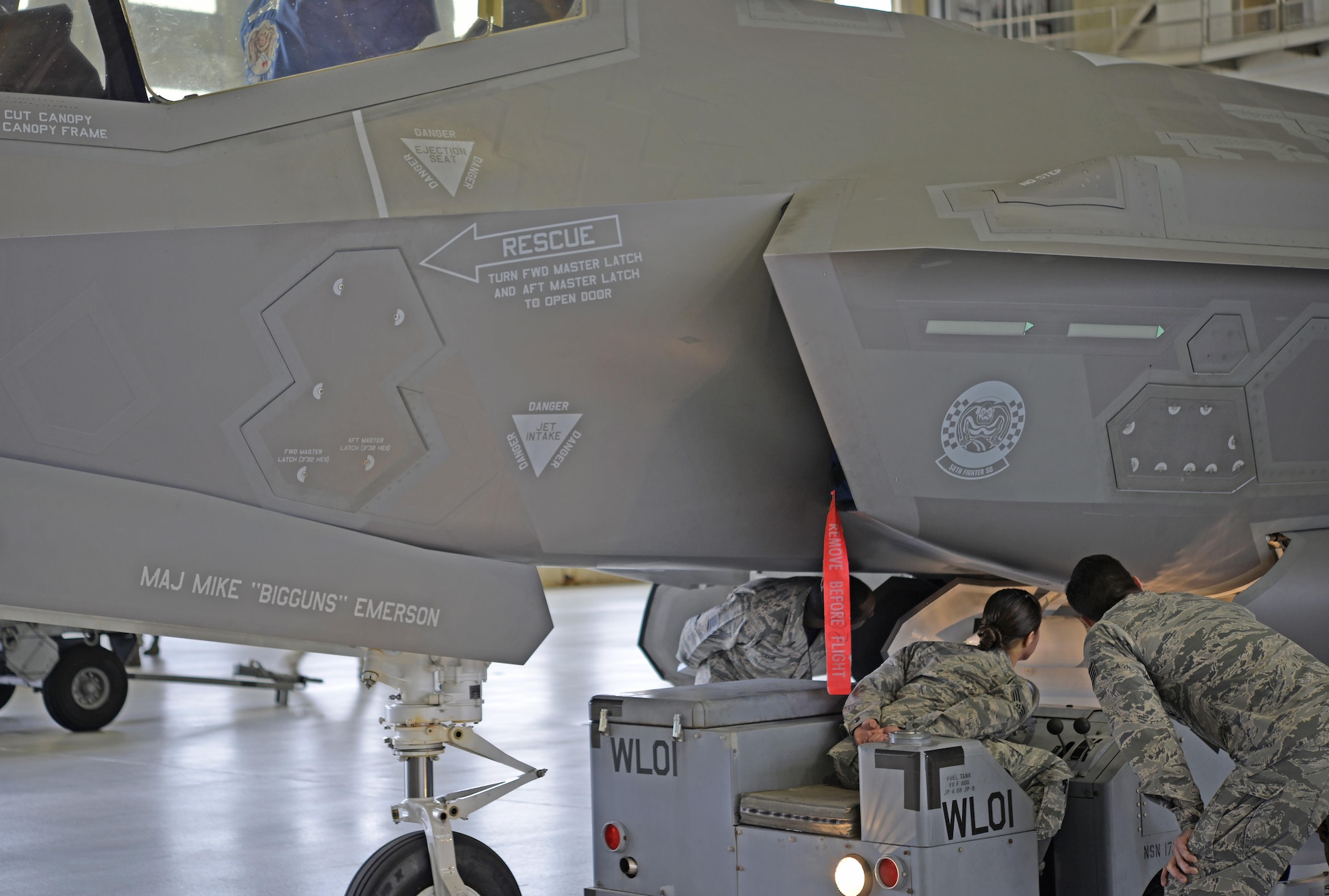 Load crew members from the 33rd Fighter Wing and judges watch as a weapon is loaded into an F-35A Lightning II during a weapons load competition at Eglin Air Force Base, Fla., March 18, 2016. This was the first weapons load competition here to face the 33rd FW and the 96th Test Wing against each other as they loaded weapons onto the F-35, F-15 Eagle and F-16 Fighting Falcon. During this competition load crew teams were evaluated on the level of safety, efficiency and speed demonstrated while loading munitions. (U.S. Air Force photo/Staff Sgt. Tarelle Walker)