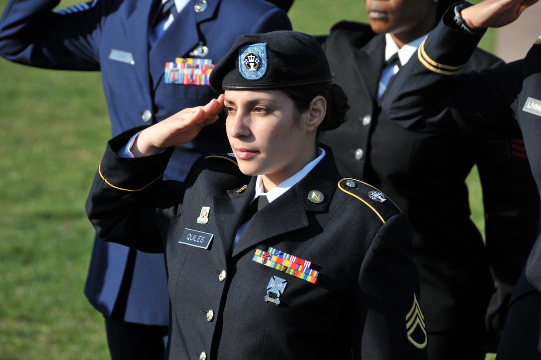 Staff Sgt. Sonia Quiles, a budget specialist in the Directorate of Resource Management at the U.S. Army Reserve's 99th Regional Support Command, salutes the U.S. flag as it is lowered during a special ceremony  March 23 as part of Women's History Month on Joint Base McGuire-Dix-Lakehurst, New Jersey.