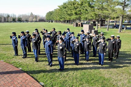 A formation of women from the Army, Air Force and Navy salute the U.S. flag as it is lowered during a special ceremony March 23 as part of Women's History Month on Joint Base McGuire-Dix-Lakehurst, New Jersey.