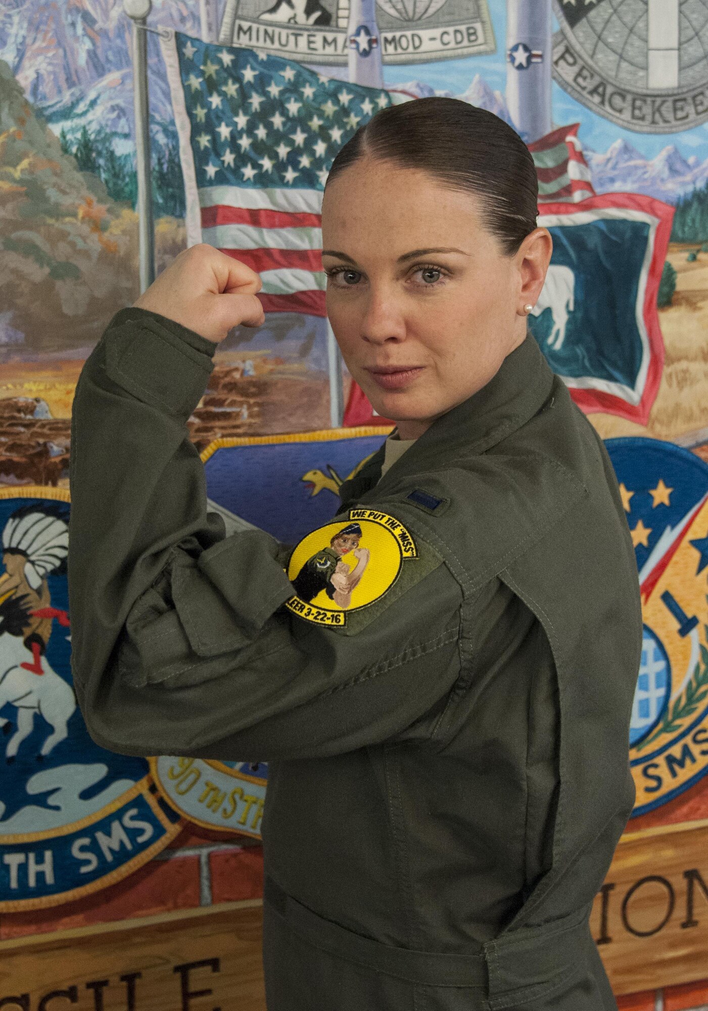 First Lt. Kelly Gorham, 320th Missile Squadron missile combat crew commander, poses March 22, 2016 in the 90th Operations Group building wearing a patch commemorating that day's all-female missile crew contingent at F.E. Warren Air Force Base, Wyo. Gorham and fellow female missileers commanded the launch control centers controlled by the base in honor of Women’s History Month. (U.S. Air Force photo by Senior Airman Jason Wiese). 